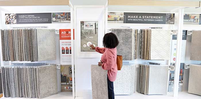 Woman browsing carpet swatches in showroom